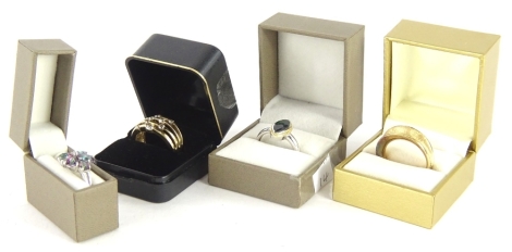 Four modern dress rings, comprising a silver and CZ set four row ring, a silver multi coloured stone ring, a silver marquise shaped dress ring, a silver gilt curved dress ring. (4)