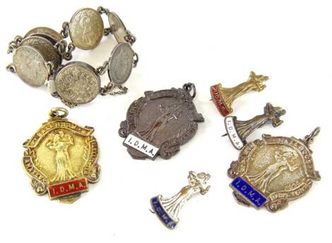 Three ballroom dancing silver fobs or medals, three associated badges and a silver threepence bracelet. (7)