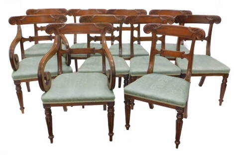 A set of ten mahogany dining chairs, each in George IV style, each with a leaf carved and panelled bar back, a padded seat on turned readed tapering legs, two with arms. The upholstery in this lot does not comply with the 1988 (Fire & Fire Furnishing) Reg