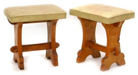 A pair of oak stools by Tom 'Gnomeman' Whittaker, each with a leatherette padded set, on end supports, 38cm W. The upholstery in this lot does not comply with the 1988 (Fire & Fire Furnishing) Regulations, unless sold to a known exporter or upholsterer it