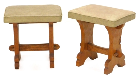 A pair of oak stools by Tom 'Gnomeman' Whittaker, each with a leatherette padded set, on end supports, 38cm W. The upholstery in this lot does not comply with the 1988 (Fire & Fire Furnishing) Regulations, unless sold to a known exporter or upholsterer it