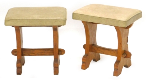 A pair of oak stools by Tom 'Gnomeman' Whittaker, each with a leatherette padded set, on end supports, 38cm W. The upholstery in this lot does not comply with the 1988 (Fire & Fire Furnishing) Regulations, unless sold to a known exporter or upholsterer it