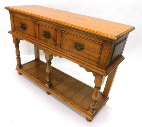 A light oak dresser, the rectangular top with a moulded edge above three frieze drawers, on turned supports with pot board and bun feet, 120cm W.