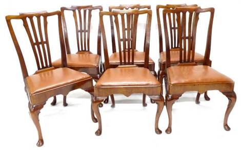 A set of six early 20thC walnut dining chairs in mid 18thC style, each with a shaped back with pierced vase shaped splat, brown drop in leatherette seat on cabriole legs with pad feet.