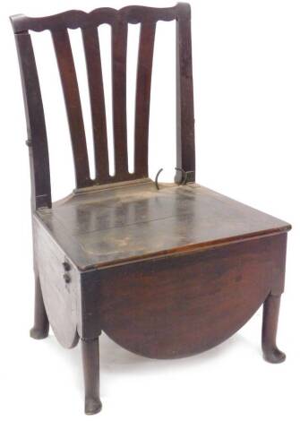 A large 19thC country made oak commode chair, with a pierced splat, the hinged lid enclosing a ceramic bowl on turned tapering legs with pad feet.