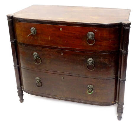 An early 19thC mahogany D shaped chest of drawers, the top with a readed edge above three long drawers, each with lion mask handles, flanked by ring turned pilasters, on tapering feet, (AF), 106cm W.