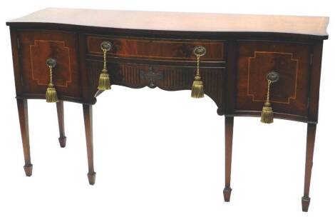 A mahogany sideboard in George III style, the top with a crossbanded boxwood strung border above two frieze drawers, flanked by two serpentine fronted flat panelled doors, on square tapering legs with spade feet, 165cm W.