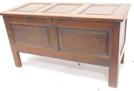 A late 18th/early 19thC oak coffer, the panelled top enclosing a vacant interior on stiles, 110cm W.