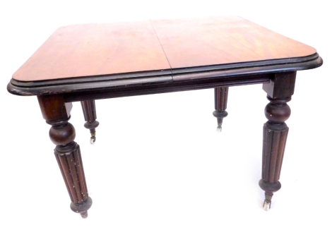 A Victorian mahogany extending dining table, the rectangular top with a moulded edge on turned tapering fluted legs with ceramic castors, one loose leaf, 70cm H, the top 103cm x 44cm.