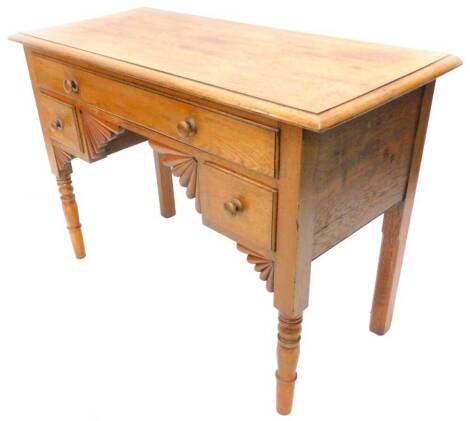 A small oak dressing table, the rectangular top with a moulded edge above a frieze drawer and two small drawers, with fan shaped brackets on turned tapering legs, 102cm W.