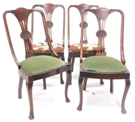 A set of four Edwardian mahogany dining or side chairs, each with a pierced splat carved with swags, etc., a padded seat on cabriole legs with pad feet. (AF)