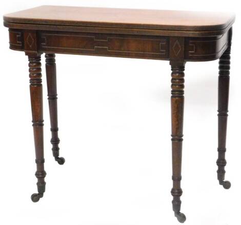 An early 19thC mahogany tea table, the rectangular D shaped top with a readed edge above a panelled frieze on ring turned tapering legs with brass castors, 84cm W.