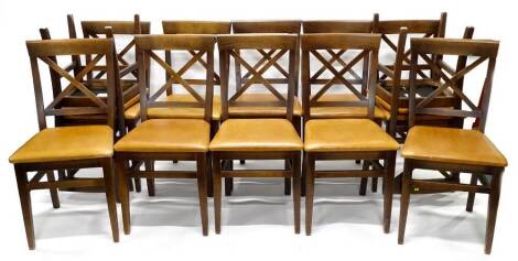 A set of ten stained beech dining chairs, each with an x shaped back, a brown leatherette seat, on square tapering legs.