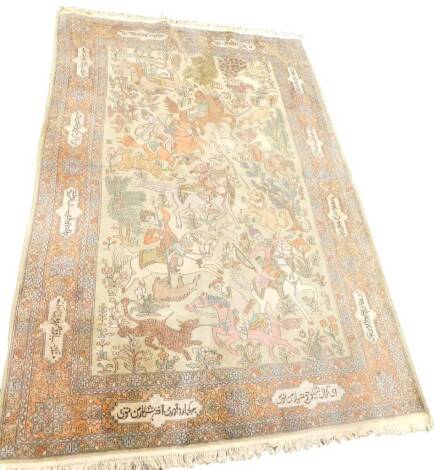 An Indian Kashmir rug, decorated with hunting scenes involving leopards, lions, etc., on a beige ground with inscribed borders, 280cm x 187cm.