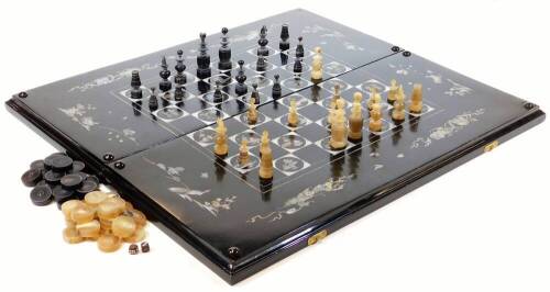 An Oriental design black lacquer and mother of pearl finish games box, of rectangular form, with chequer board exterior, and back gammon set to the interior, decorated with a mother of pearl finish of birds, scrolls, etc. when closed 5cm H x 62cm W x 29cm