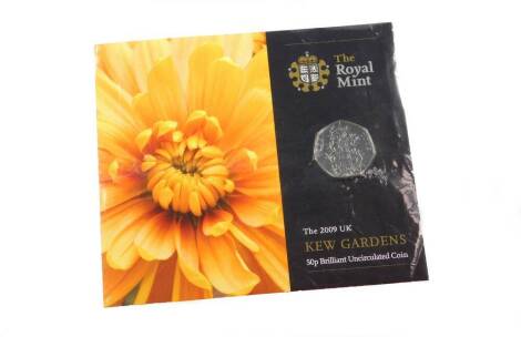 A Royal Mint 2009 Kew Gardens fifty pence uncirculated coin, with paperwork and outer wrapper.