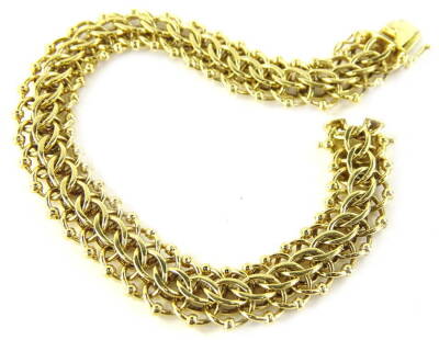 A modern fancy link bracelet, formed with triple hoop links, with double clip clasp, yellow metal, stamped 750, 44.5g, 21cm L.