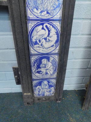A pair of Victorian cast iron fire surrounds, each set with twelve Minton tiles, printed in blue with a design of Aesops Fables, after Moyr-Smith, 97cm H, 97.5cm W. Provenance: Removed from Leyland House, Nettleham Road, Lincoln. The house was designed by - 5
