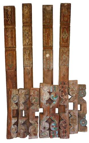 A set of four antique Moroccan architectural pilaster columns, and a set of eight associated capitals & plinths, in traditional polychrome colours, 2m H.