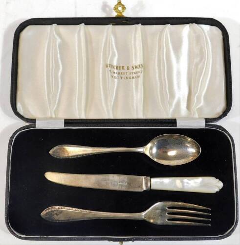 An Elizabeth II silver three piece christening set, comprising knife, fork and spoon, the knife with mother of pearl handle, Sheffield 1958/59, in fitted presentation case.