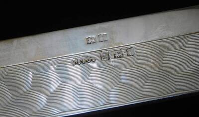 An Elizabeth II silver table cigarette box, of low rectangular design, with hinged lid and having beaten effect decoration, Birmingham 1973, 22.2cm H, 9.9cm W, 3cm D. - 3