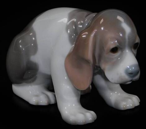 A Lladro figure of a puppy, head lowered, printed marks beneath, 8cm H.