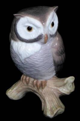 A Lladro figure of an owl, on tree bough, printed marks beneath, 9cm H.