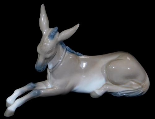 A Lladro figure of a recumbent donkey, printed marks beneath, 10cm H.