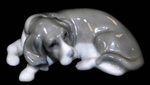 A Lladro figure of a sleeping puppy, printed marks beneath, 7cm W.