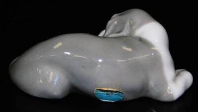 A Lladro figure of a sleeping puppy, printed marks beneath, 7cm W. - 2