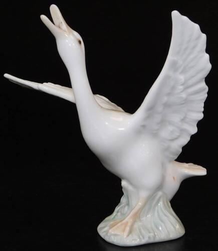 A Lladro figure of a goose, wings outstretched, no. 1263, printed and impressed marks beneath, 13cm H.