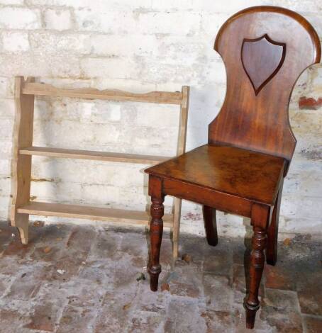 A 19thC mahogany hall chair, the shaped back with raised shield above plain seat on turned front legs, on turned front and sabre back legs, 89cm H, and a pine hanging shelf with three shelves and shaped sides. (2)