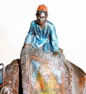 A cast and painted spelter figural table lighter, in the manner of Bergmann, formed as an Arabian rug seller on a camel's back, aside a further figure, on a rectangular base, 19cm H. (AF) - 5