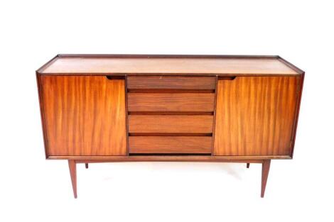 A mid 20thC teak sideboard possibly Danish, with four central graduated drawers, having horizontally fluted fronts, the upper drawer divided into sections, flanked by two cupboard doors, enclosing shelves, raised on tapering square legs, 86cm H, 152.5cm W