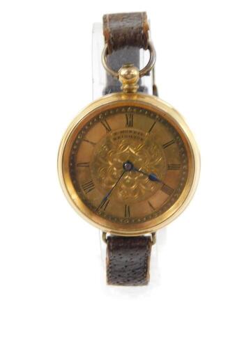 A lady's 18ct gold cased pocket watch, by E. Morris, Brighton, open faced, key wind, engraved floral dial with chapter ring bearing Roman numerals, the case with engine turned decoration, with key, later converted to wristwatch form with leather strap, 38