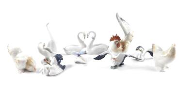 Lladro porcelain figures of birds, including three storks, cockerel and hen, a pair of swans, their necks entwined as a heart, geese, etc., together with a porcelain butterfly. (10)