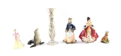 A Lomonosov porcelain figure of a seal, Royal Doulton figure Southern Belle, HN2229, Royal Worcester figure Winter's Morn, Coalport figure Jacqueline, German porcelain vase decorated with floral sprays, and a Beswick Beatrix Potter figure modelled as Ben