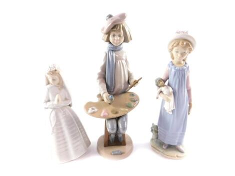 A Lladro porcelain figure of a girl, modelled standing holding a rag doll, 28cm H, together with a Nao porcelain figure of a boy artist, modelled seated with a pallet and tube of paint and paint brush, 22cm H, and a Nao figure of a bride, 24cm H. (3)