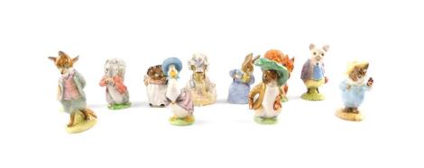 A group of Beswick Beatrix Potter figures, brown back stamp, comprising Foxy Whiskered Gentleman, Squirrel Nutkin, Mrs Flopsy Bunny, Lady Mouse, Jemima Puddle-Duck, Mrs Tiggywinkle, Timmy Tiptoes, Cotton Tail, Pigling Bland, Tom Kitten and Butterfly, and 