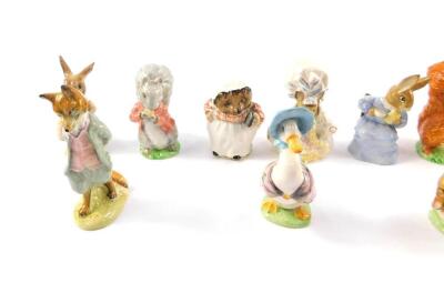 A group of Beswick Beatrix Potter figures, brown back stamp, comprising Foxy Whiskered Gentleman, Squirrel Nutkin, Mrs Flopsy Bunny, Lady Mouse, Jemima Puddle-Duck, Mrs Tiggywinkle, Timmy Tiptoes, Cotton Tail, Pigling Bland, Tom Kitten and Butterfly, and - 2