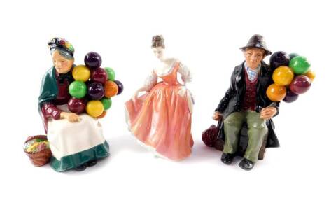 Three Royal Doulton figures, comprising The Old Balloon Seller HN1315, The Balloon Man HN1954, and Fair Lady (coral pink) HN2835.