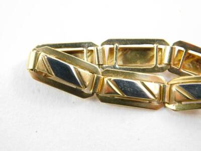 A bicolour rectangular link bracelet, on a bolt ring clasp, stamped 18ct, 6.2g. - 2