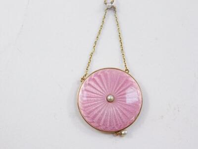 An Edwardian circular pink guilloche enamel locket pendant, in yellow metal with seed pearls, on a chain, stamped 9ct, 9.4g. - 2