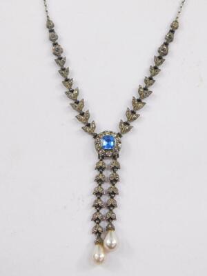 An Edwardian blue and clear paste necklace, set in white metal, in a floral and leaf design with two graduated simulated baroque pearl drops. - 2