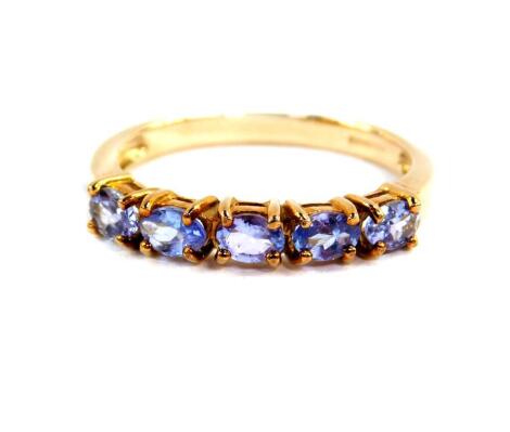 A 9ct gold and tanzanite five stone ring, size O, with certificate, 1.9g.