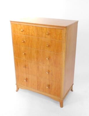 A mid 20thC satin walnut and plywood chest of drawers, having two short over four long graduated drawers, raised on outswept feet, 117cm H, 85cm W, 47cm D.