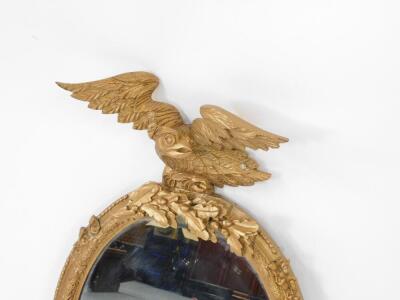 A Victorian oval gesso wall mirror, later gilt painted, with eagle surmount resting on acorns and oak leaves, the frame with floral decoration and beaded edging, and acorns and oak leaves to the bottom, 83cm H, 49.5cm W. - 2