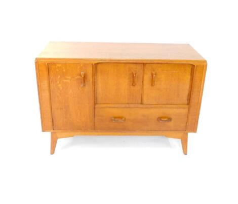 A mid 20thC G-Plan oak sideboard, with two doors above a frieze drawer, flanked to the left by a cupboard door enclosing a single shelf, raised on splayed legs, 84.5cm H, 122cm W, 46cm D.