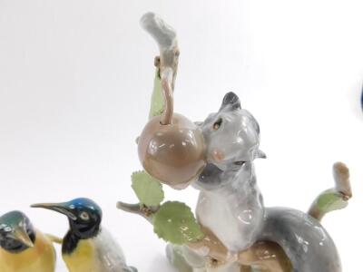 A Royal Doulton figure modelled as Autumn Breezes HN1934, Lladro porcelain figure of a squirrel with a nut, Lladro goose group and two single geese, and a Karl Ens porcelain figure of a pair of penguins. (6) - 2