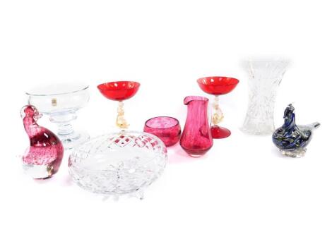 A pair of Venetian ruby glass pedestal sweetmeat dishes, raised on dolphin stems, 15cm H, a Holmegaard cut glass pedestal fruit bowl, 15.5cm H, a Wedgwood glass figure of a duck, further glass bird, cranberry glass jug, and sundry further glass. (9)